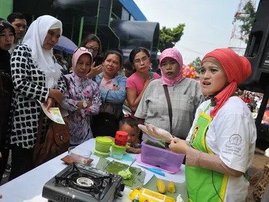 Sejumlah ibu-ibu melihat juru masak membuat jajanan tradisional di Pasar Pondok Labu, Jakarta Selatan (10/09). Acara yang diusung Gulaku untuk melestarikan jajanan tradisional Indonesia. (Liputan6.com/Gempur M Surya). 