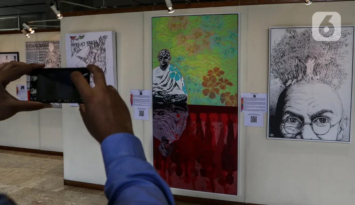 Pengunjung melihat karya lukis dan karya foto pada pameran 150 Tahun Mahatma Gandhi di kompleks Parlemen, Senayan, Jakarta, Jumat (2/10/2020). Pameran ini kerjasama Kedubes India dan DPR mengambil tema "kebenaran, anti kekerasan dan Satyagraha". (Liputan6.com/Johan Tallo)