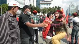 Suasana saat massa gabungan dari berbagai elemen buruh dan organisasi mahasiswa berunjuk rasa memperingati Hari Buruh atau May Day di area Patung Kuda, Jakarta, Sabtu (1/5/2021). Polisi mengamankan sejumlah massa yang diduga mahasiswa dalam aksi unjuk rasa tersebut. (merdeka.com/Imam Buhori)