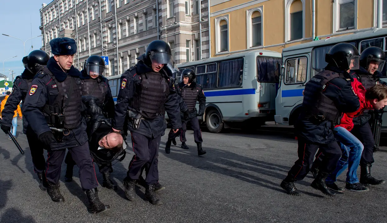 Polisi Rusia menangkap pengunjuk rasa dalam protes anti-korupsi di pusat kota Moskow, Minggu (26/3). Alasan penahanan adalah aksi demo disebut ilegal karena dilakukan tanpa mengajukan perizinan resmi kepada otoritas keamanan Rusia. (Alexander UTKIN/AFP)