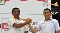 Wiranto dan Hary Tanoesoedibjo melakukan salam komando sebagai salah satu bukti optimis mendekati Pemilu 9 April mendatang (Liputan6.com/Panji Diksana) 