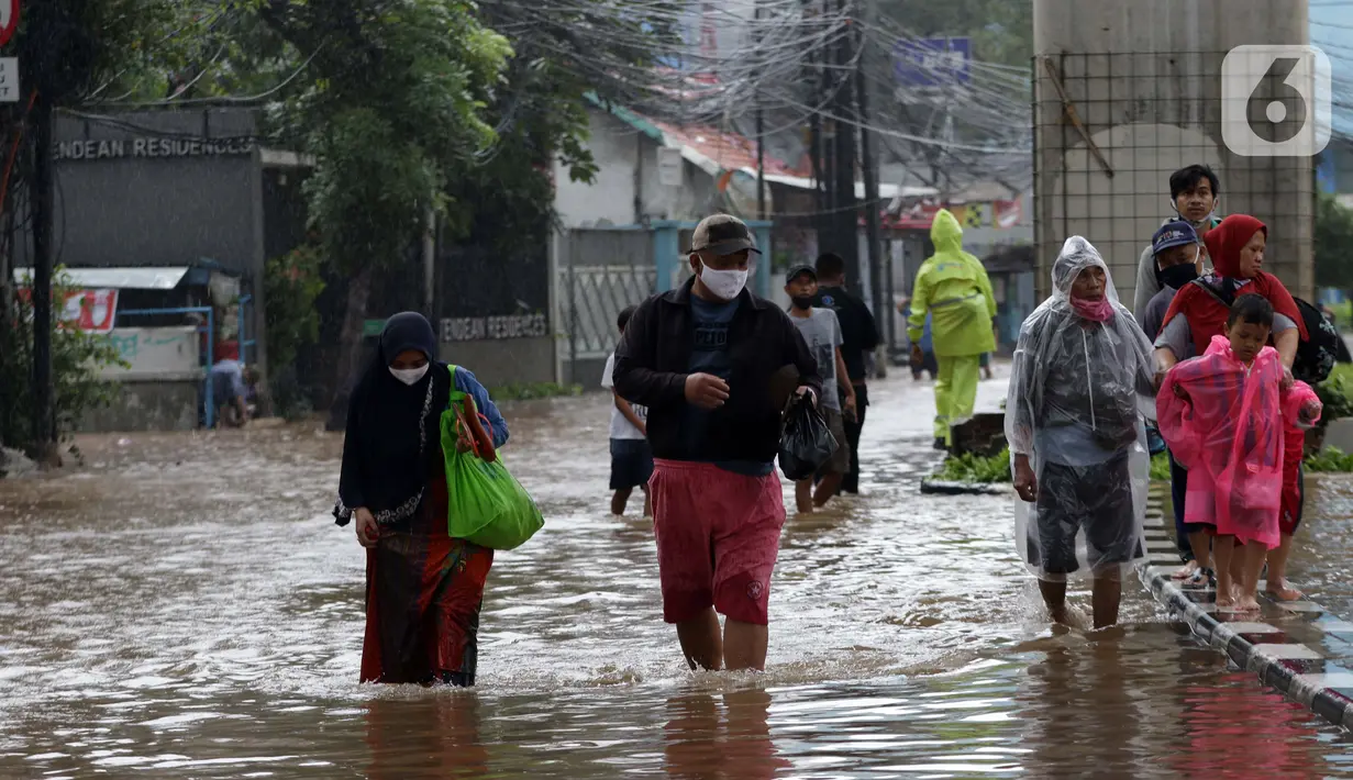 Warga berjalan menyusuri banjir yang menggenangi kawasan Jalan Wolter Monginsidi Jakarta dan sekitarnya, Sabtu (20/2/2021). Hujan yang mengguyur Jakarta sejak Jumat (19/2) membuat sejumlah titik di Jakarta terendam banjir. (Liputan6.com/Helmi Fithriansyah)