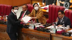 Ketua DPR Puan Maharani menerima berkas laporan pemerintah terkait RUU permasyarakatan dari Menteri Hukum dan HAM Yasonna Laoly (kanan) saat rapat paripurna ke-28 masa persidangan V tahun 2021-2022 di Kompleks Parlemen, Senayan, Jakarta, Kamis (7/7/2022). Rapat Paripurna tersebut mendengarkan pendapat fraksi terhadap RUU usul inisiatif Komisi IV DPR tentang konservasi sumber daya alam hayati dan ekosistemnya. (Liputan6.com/Angga Yuniar)