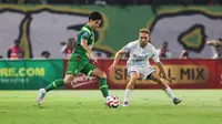 Pemain Persebaya Surabaya, Bruno Moreira (kanan) dijaga ketat oleh pemain PSIM Yogyakarta, Ze Valente pada pertandingan pembuka BRI Super League 2025/2026 di Stadion Gelora Bung Tomo, Jumat (08/08/2025) malam WIB. (Bola.com/Abdul Aziz)
