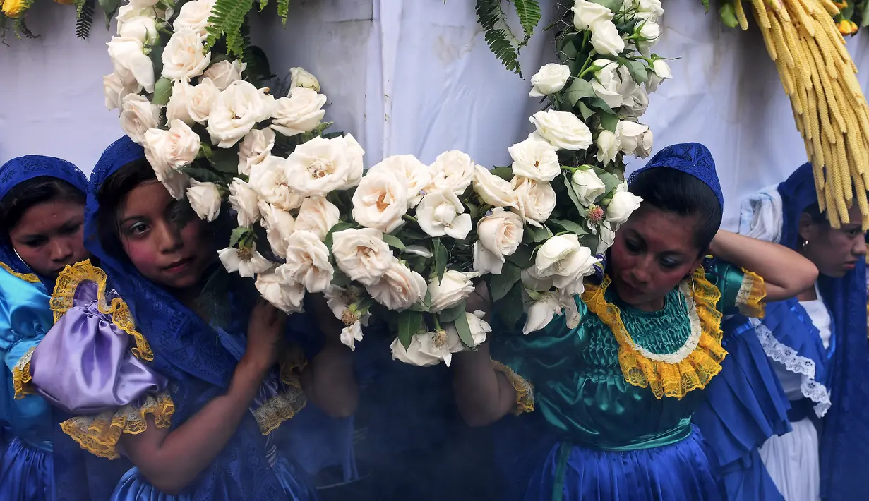 Sejumlah wanita mengenakan kostum berpartisipasi dalam acara festival tahunan Panchimalco Flower and Palm Festival di Panchimalco, San Salvador (6/5). (AFP/Marvin Recinos)