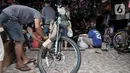 Pekerja merakit sepeda yang telah dibeli di salah satu toko di Kramat Jati, Jakarta, Minggu (21/6/2020). Dalam sebulan terakhir, penjualan sepeda di Ibu Kota meningkat tajam seiring minat dan tren warga yang melonjak menggunakan transportasi gowes itu di masa pandemi. (merdeka.com/Iqbal Nugroho)