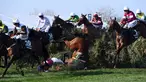 Seorang joki bernama Rachael Blackmore terjungkal bersama kudanya saat mengikuti pacuan kuda Grand National di Aintree Racecourse di Liverpool, Inggris (14/4). Rachael Blackmore mengalami cedera akibat insiden itu. (AFP/Paul Ellis)