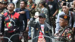 Anggota dan simpatisan Barisan Ansor Serbaguna (Banser) berunjuk rasa menentang keputusan Komisi Pemberantasan Korupsi (KPK) terkait penahanan Menteri Agama periode 2020-2024, Yaqut Cholil Qoumas. Tampak dalam foto, anggota dan simpatisan Barisan Ansor Serbaguna (Banser) saat berunjuk rasa di depan gedung Merah Putih Komisi Pemberantasan Korupsi (KPK), Jakarta, Kamis (12/3/2026). (Liputan6.com/Helmi Fithriansyah)