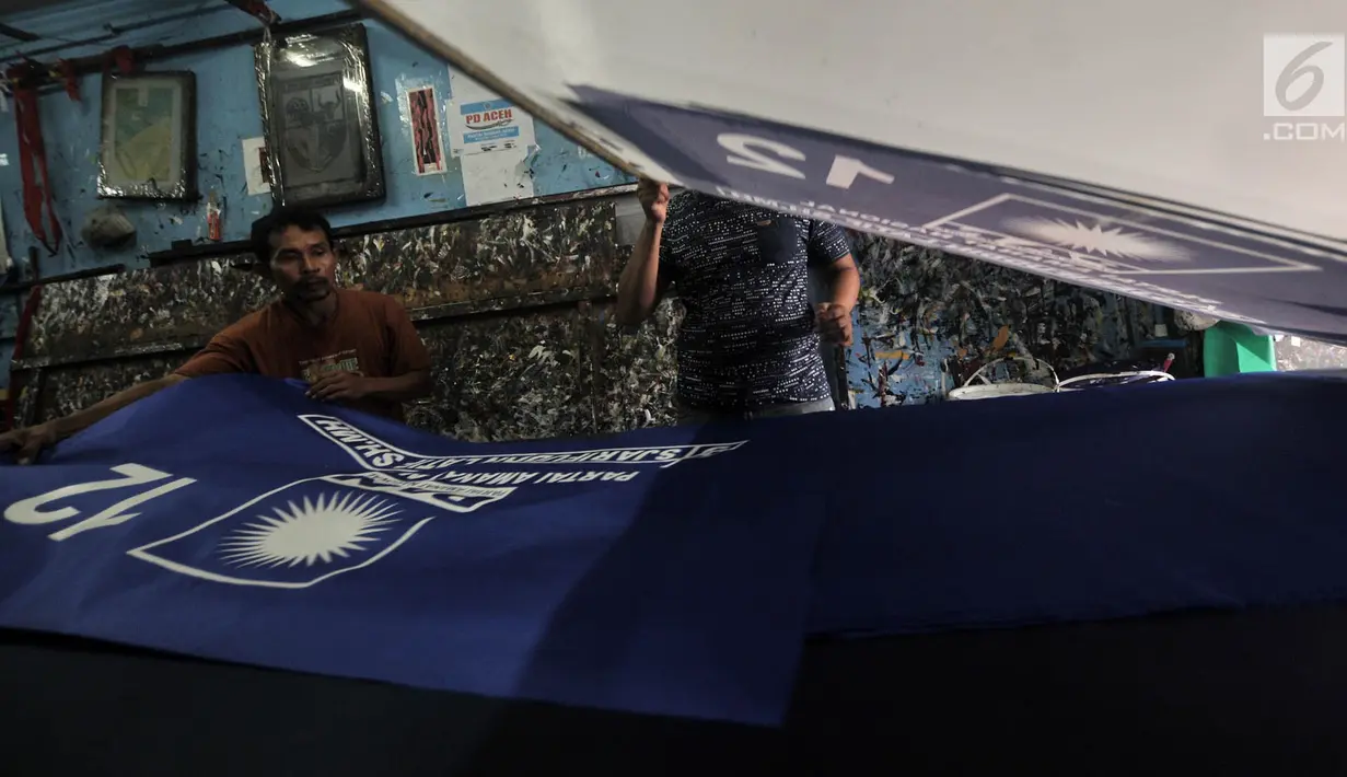 Pekerja mencetak bendera partai politik di Percetakan Andalas Jaya, Jakarta, Rabu (2/1). Omzet dari percetakan sablon bendera dan spanduk partai ini mencapai Rp 60 juta per minggu dengan keuntungan hingga 40 persen. (Merdeka.com/Iqbal Nugroho)