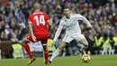 Striker Real Madrid, Cristiano Ronaldo, berusaha melewati gelandang Sevilla, Guido Pizarro, pada laga La Liga di Stadion Santiago Bernabeu, Minggu (10/12/2017). Real Madrid menang 5-0 atas Sevilla. (AP/Francisco Seco)