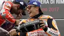 Pebalap Repsol Honda Team, Marc Marquez merayakan keberhasilan meraih podium sebagai yang tercepat pada balapan MotoGP San Mariono di Sikuit Marco Simoncelli, Misano Adriatico, Italia (10/9/2017). (AP/Antonio Calanni)