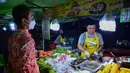 <p>Penjual membuat makanan untuk pembeli  selama bulan suci Ramadhan di pasar malam di provinsi Narathiwat, Thailand selatan (21/4/2022). Penjual makanan jalanan mendirikan kios mereka untuk menjual makanan kepada umat Muslim untuk berbuka puasa. (AFP/Madaree Tohlala)</p>