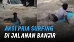 Aksi pria surfing di jalanan saat banjir menarik perhatian.