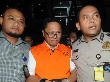 Kadis Kelautan dan Perikanan Kepri Edy Sofyan dikawal petugas usai menjalani pemeriksaan 1 x 24 jam di Gedung KPK, Jakarta, Jumat dini hari (12/7/2019). Edy Sofyan resmi ditahan KPK bersama Gubernur Kepri Nurdin Basirun terkait suap izin lokasi rencana reklamasi di Kepri. (merdeka.com/Dwi Narwoko)