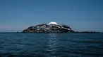 Gambar 5 Oktober 2018, menunjukkan atap seng yang baru dibangun bersinar di atas pulau Migingo di Danau Victoria. Pulau dengan luas 0.49 hektar atau setengah dari ukuran lapangan sepak bola ini berada di perbatasan Uganda dan Kenya. (Yasuyoshi CHIBA/AFP)