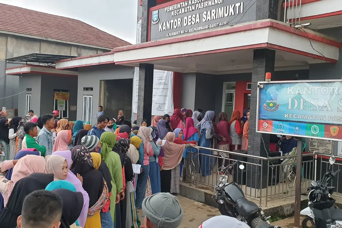 Antrian KPM penerima bantuan BLT minyak goreng di depan desa Sarimukti, Kecamatan Pasirwangi Garut, Jawa Barat