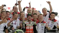 Pebalap LCR Honda, Cal Crutchlow (tengah), merayakan gelar juara pada MotoGP Argentina di Sirkuit Termas de Rio Hondo, Minggu (8/4/2018). Pebalap Inggris itu mencatatkan waktu 40 menit 36.342 detik. (AFP/Juan Mabromata)