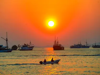 Sebuah perahu melintas di perairan Labuan Bajo, Flores, Nusa Tenggara Timur sesaat sebelum matahari terbenam. Labuan Bajo, kota kecil di ujung barat Pulau Flores, Nusa Tenggara Timur, terus berkembang menjadi salah satu destinasi wisata unggulan Indonesia. (merdeka.com/Arie Basuki)