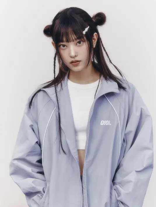 Penampilan menarik lainnya dari Haerin NewJeans. Ia mengenakan crop top putih dipadu dengan jaket parasut abu-abu berukuran besar. Rambutnya pun ditata dengan gaya Y2K. Foto: Instagram.