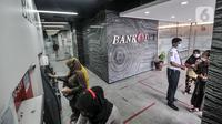Warga mencairkan dana bantuan sosial tunai (BST) di ATM Bank DKI kawasan Matraman, Jakarta, Rabu (21/7/2021). BST disalurkan melalui rekening Bank DKI sebesar Rp 600 ribu per KK yang merupakan rapelan tahap 5 dan 6 atau bulan Mei dan Juni. (merdeka.com/Iqbal S. Nugroho)