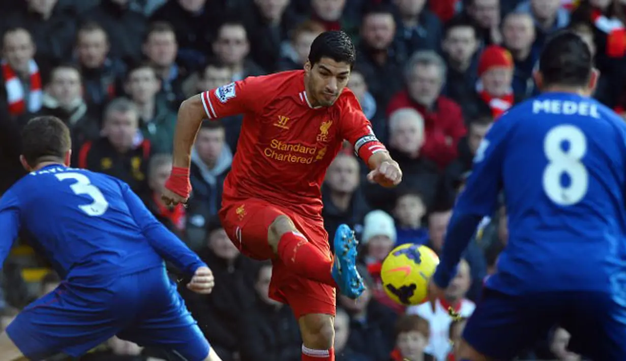 Striker Liverpool Luis Suarez di hadang Pemain Cardiff City Andrew Taylor dan Gary Medel pada pertandingan sepak bola Liga Utama Inggris antara Liverpool dan Cardiff City di stadion Anfield. Sabtu 21 Desember 2013.(AFP/Paul Ellis).