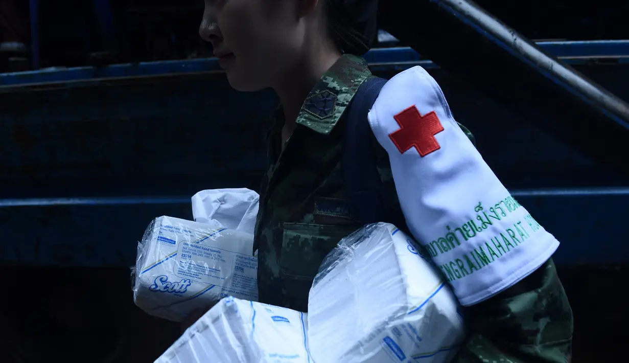 Tentara Thailand membawa persedian medis selama operasi penyelamatan untuk tim sepak bola remaja yang hilang dan pelatih mereka di Taman Hutan Non Khun Nam Nang dekat gua Than Luang di provinsi Chiang Rai, Thailand (28/6). (AFP Photo/Lillian Suwanrumpha)