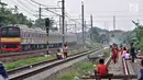 Anak-anak bermain layang-layang di rel kereta api kawasan Jakarta Timur, Kamis (3/1). Minimnya lahan terbuka hijau memaksa anak-anak setempat memilih kawasan rel kereta api sebagai lokasi bermain. (Merdeka.com/Iqbal Nugroho)