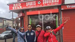 Sebelum berangkat ke Old Trafford, foto bareng dulu bersama rekan-rekan dari Indonesia di depan toko yang menjual atribut Manchester United. (Bola.com/Joko Setyo Pramuji)