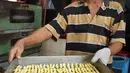Pekerja membawa adonan kue kering saat proses pembuatan di industri rumahan kawasan Kwitang, Jakarta, Sabtu (18/5/2019). Penjualan kue kering jelang Lebaran meningkat hingga 50 persen dibanding hari-hari biasanya. (Liputan6.com/Herman Zakharia)