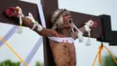 Wilfredo Salvador meringis setelah dia dipaku pada kayu salib saat memperagakan kembali penderitaan Yesus Kristus sebagai bagian dari ritual Jumat Agung di Desa San Pedro, Cutud, Provinsi Pampanga, Filipina, Jumat (7/4/2023). Penyaliban di kehidupan nyata, tradisi Jumat Agung berdarah yang ditolak oleh gereja Katolik, dilanjutkan di desa pertanian ini setelah jeda tiga tahun karena pandemi virus corona COVID-19. (AP Photo/Aaron Favila)