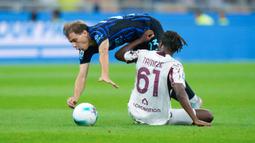 Pemain Inter Milan, Nicolo Barella, terjatuh saat berebut bola dengan pemain Torino, Adrien Tameze, pada laga pekan perdana liga Italia di Stadion Giuseppe Meazza, Selasa (26/8/2025) dini hari WIB. (AP Photo/Luca Bruno)