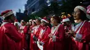 Mereka bersama-sama menyanyikan kidung serta lagu Natal secara massal bersama warga. Tampak dalam foto, Umat Kristiani berdoa bersama sebelum menyanyikan lagu-lagu Natal di Jakarta, Indonesia, Selasa, 23 Desember 2025. (AP Photo/Dita Alangkara)