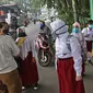 Sejumlah murid  memasuki sekolah  SD Negeri 6, Bekasi, Jawa Barat, Selasa (4/8/2020). Pemerintah setempat memberikan izin kepada enam sekolah untuk melakukan uji coba pembelajaran tatap muka selama satu bulan. (Liputan6.com/Herman Zakharia)