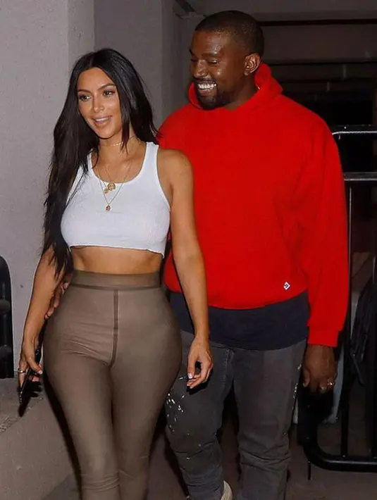 Menikmati momen  berharganya bareng suami, Kim terlihat memakai crop top berwarna putih dan dipadukan dengan celana legging ketat berwarna cokelat. Tak heran jika tubuh Kim terlihat begitu seksi saat itu. (Doc. Daily Mail)