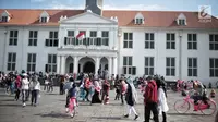 Pengunjung berwisata di depan Museum Sejarah Kota Tua, Jakarta, Kamis (27/12). Kawasan wisata Kota Tua dipadati wisatawan dari dalam kota maupun luar kota Jakarta selama libur sekolah. (Liputan6.com/Faizal Fanani)