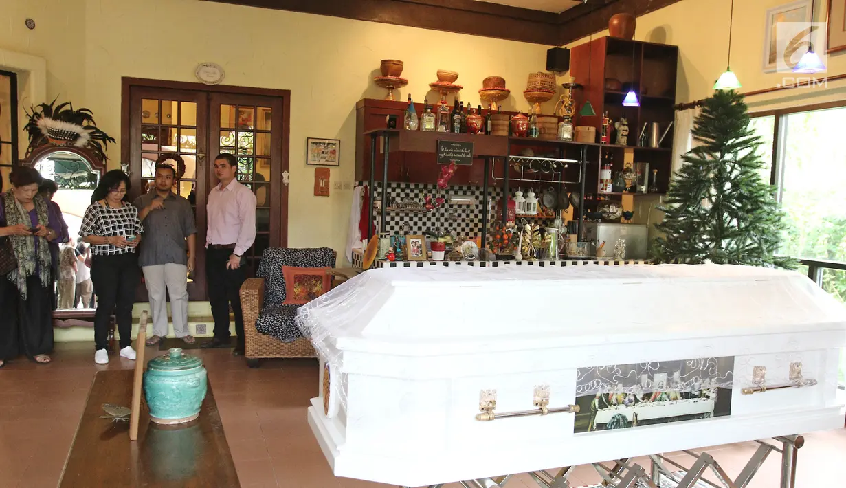 Sejumlah orang berdiri dekat peti jenazah pakar kuliner Bondan Winarno saat disemayamkan di rumah duka kawasan Sentul, Bogor, Rabu (29/11). Bondan meninggal pada usia 67 tahun karena penyakit jantung yang dideritanya. (Liputan6.com/Herman Zakharia)