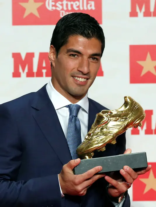 Senyum semringah Luis Suarez saat berpose dengan trofi Sepatu Emas Eropa 2016 di Barcelona, Spanyol (20/10). Suarez mencetak gol terbanyak dalam liga domestik di Eropa. (REUTERS/Albert Gea)