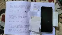 Buku catatan peninggalan IRT yang bunuh diri di Pinrang (Liputan6.com)