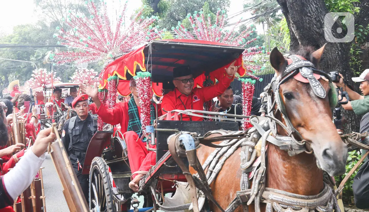 Di bagian tengah barisan, Hasto Kristiyanto yang menjadi pimpinan rombongan arak-arakan menaiki sebuah andong bersama dengan Ketua DPP PDIP yang juga Wakil Ketua MPR Ahmad Basarah. (Liputan6.com/Herman Zakharia)