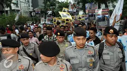 Polisi berjaga saat Front Pemuda Muslim Maluku (FPMM) menggelar aksi di depan KPK, Jakarta, Jumat (26/8). Mereka mendesak KPK mengusut Bupati Buru yang diduga melakukan korupsi. (Liputan6.com/Helmi Afandi)