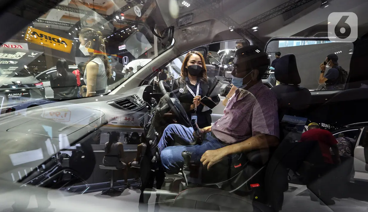 Pengunjung menjajal mobil yang dipamerkan pada hari kedua pameran Indonesia International Motor Show (IIMS) 2023 di JIExpo Kemayoran, Jakarta Pusat, Jumat (17/2/2023). IIMS 2023 yang berlangsung hingga 26 Februari mengangkat tema "Bringing Opportunity for Otomotive Society Together" (BOOST) dan menghadirkan sekitar 40 merek otomotif dengan menampilkan produk dan konsep terbaru. (Liputan6.com/Johan Tallo)