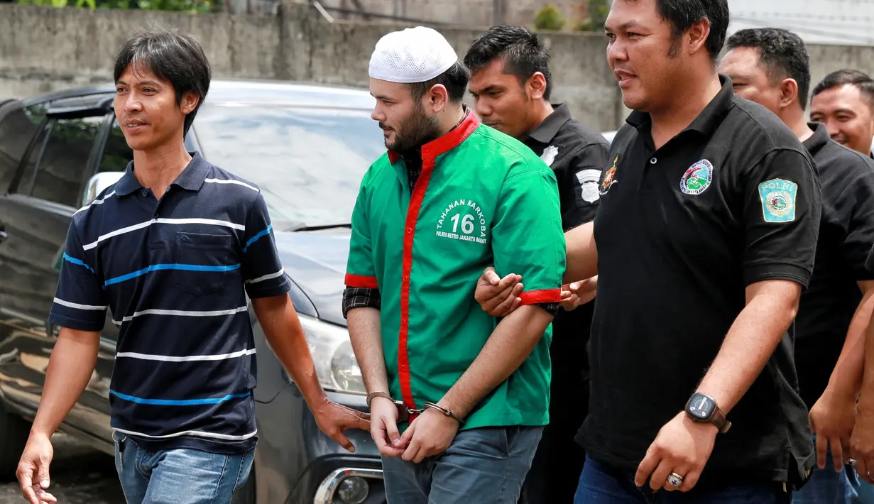 "Halo, Ridho gimana nih kabarnya," tanya awak media kepada Ridho. "Halo, Alhamdulillah sehat," jawab Ridho dengan singkat dengan tangan terborgol. (Adrian Putra/Bintang.com)