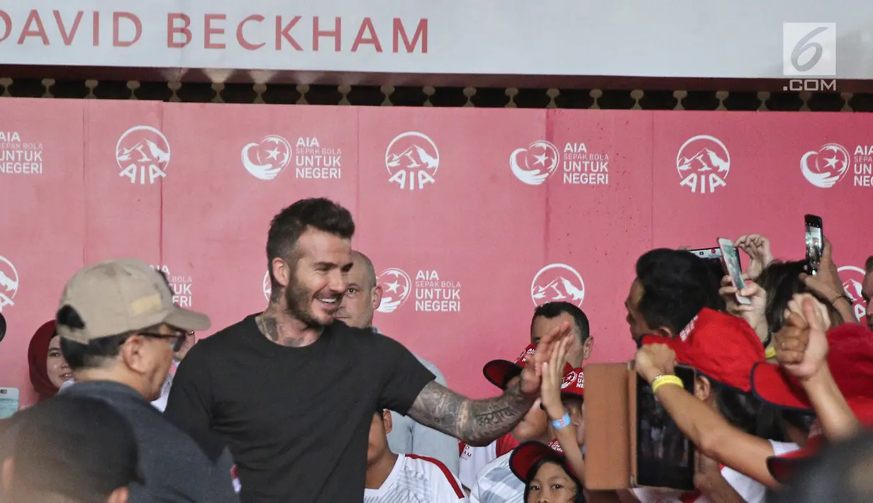 Mantan bintang sepak bola Inggris David Beckham menyapa anak-anak pada acara AIA Sepak Bola untuk Negeri di Jakarta, Minggu (25/3). Anak-anak yang terpilih berkesempatan bersalaman dengan David Beckham. (Liputan6.com/Herman Zakharia)