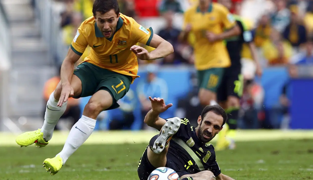 Gelandang Timnas Australia, Tommy Oar (kiri) berusaha lolos dari hadangan pemain belakang Spanyol, Juanfran, di laga penyisihan Piala Dunia 2014 Grup B di Stadion Baixada, Curitiba, Brasil, (23/6/2014). (REUTERS/Darren Staples)