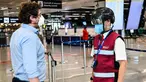 Petugas mengenakan termoscanner portabel "Smart-Helmet" untuk memeriksa suhu penumpang dan sesama staf di terminal keberangkatan bandara Fiumicino Roma, Italia pada 5 Mei 2020. Hal ini dilakukan guna menyaring orang yang memiliki gejala infeksi virus corona. (ANDREAS SOLARO/AFP)