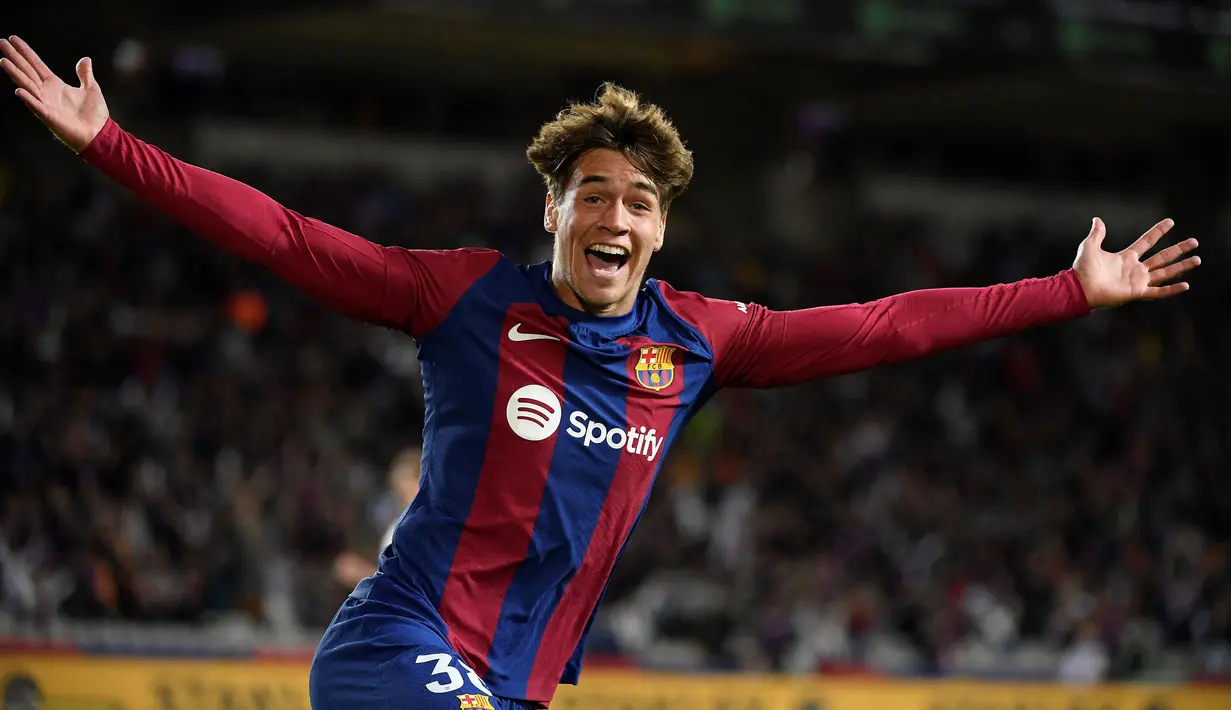 Striker muda Barcelona U-19, Marc Guiu menjadi pemain terbaru di Liga Spanyol yang mampu mencetak gol cepat di Liga Spanyol. Hanya saja, gol cepat yang dicetaknya dalam waktu 23 detik bukan dihitung sejak kick-off, namun sejak ia masuk sebagai pemain pengganti pada menit ke-83 saat laga debutnya bersama tim senior Barcelona menghadapi Athletic Bilbao pada laga pekan ke-10 Liga Spanyol musim 2023/2024. Berkat golnya, Barcelona sukses menang 1-0 atas Athletic Bilbao. (AFP/Josep Lago)