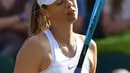 Ekspresi petenis Rusia Maria Sharapova usai kalah dari petenis Prancis, Pauline Parmentier dalam pertandingan tunggal putri di Wimbledon Tennis Championships di London, Inggris (2/7/2019). Sharapova kedua kalinya secara beruntun terdepak pada putaran pertama Wimbledon. (AFP Photo/Ben Stansall)