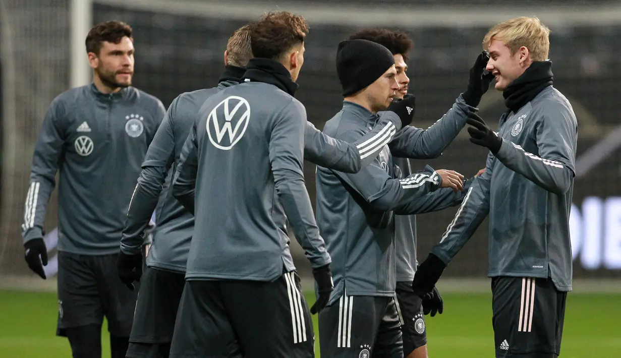 Pemain depan Julian Brandt (kanan) berbincang dengan rekan-rekannya selama sesi latihan tim di Frankfurt am Main, Jerman barat (18/11/2019). Jerman akan bertanding melawan Irlandia Utara pada Grup C Kualifikasi Piala Eropa 2020 di Commerzbank-Arena. (AFP Photo/Daniel Roland)
