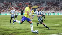 Pemain Timnas Brasil U-17,&nbsp;Kaua Elias (tengah), menendang bola dibayangi pemain Argentina U-17, Octavio Ontivero dalam pertandingan perempat final Piala Dunia U-17 2023 yang berlangsung di Jakarta International Stadium, Jumat (24/11/2023). (Bola.com/Bagaskara Lazuardi)