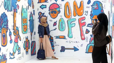 Pengunjung berfoto di salah satu stand karya seni komtemporer yang dipamerkan digelaran ON/OFF Festival di Istora Gelora Bung Karno, Jakarta, Sabtu (7/9/2019). Gelaran ON/OFF Festival akan berlangsung hingga Minggu (8/9). (Liputan6.com/Helmi Fithriansyah)